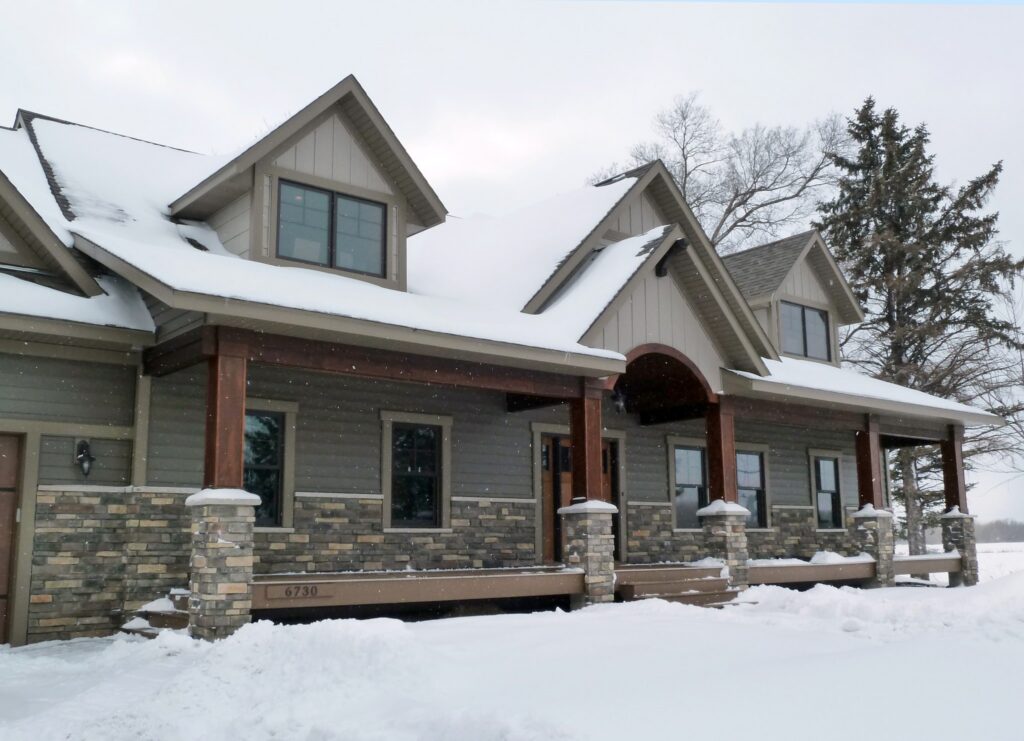 Minnesota Home In Winter Covered In Snow Featuring The Durability Of EDCO Steel Siding